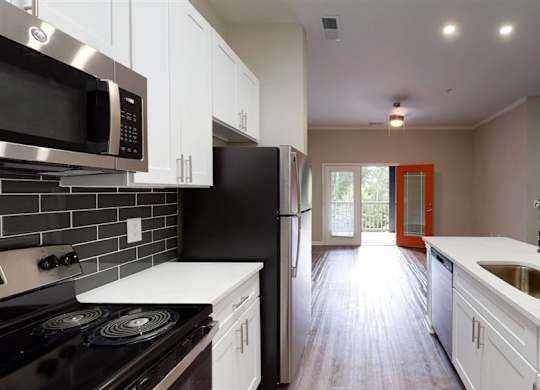 A kitchen with black and white appliances at Vue at Embry Hills, Atlanta, GA