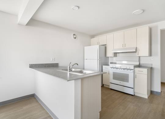 A kitchen with white appliances and wooden floors at Poplar Place Apartments, Springfield, IL