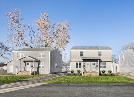 A row of houses with trees in the background at Poplar Place Apartments, Springfield, Illinois