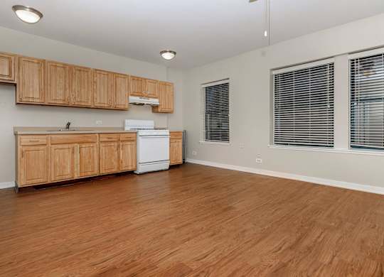 A kitchen with wooden cabinets and a white fridge at Sheridan Park, Chicago, IL