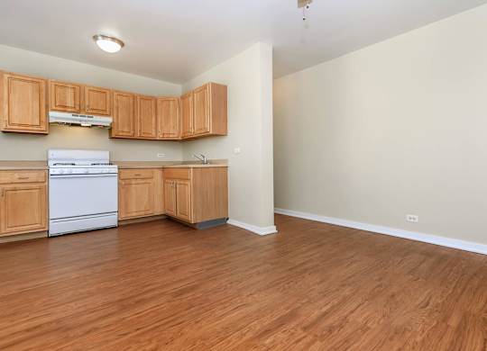A kitchen with wooden cabinets and a white dishwasher at Sheridan Park, Chicago, 60640