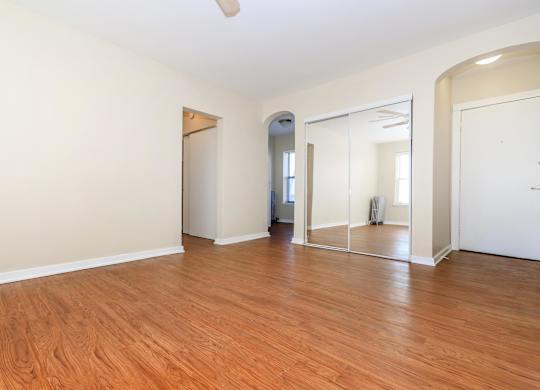 An Empty room with wooden floors and a large mirror on the wall at Sheridan Park, Chicago, IL 60640
