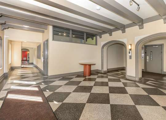 A hallway with a checkered floor and a brown carpet at Sheridan Park, Chicago, Illinois