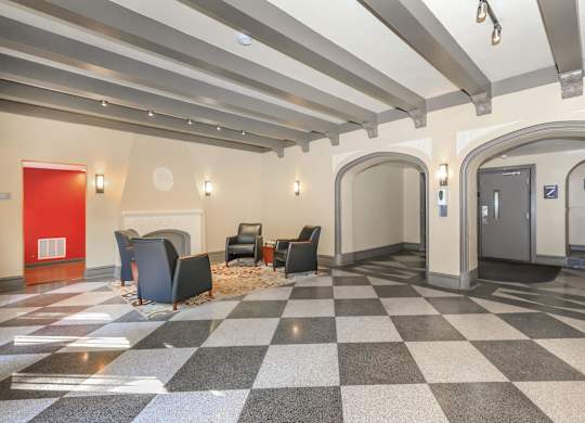 A hallway with a checkered floor and a red door at Sheridan Park, Chicago, IL 60640