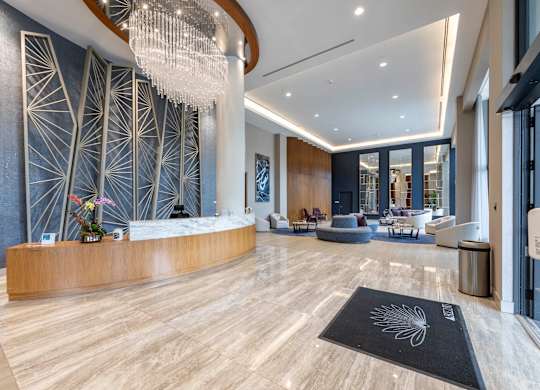 A reception area with a wooden desk  at Palma, Doral, FL, 33166