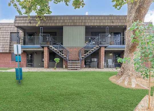 A building with a green lawn in front.