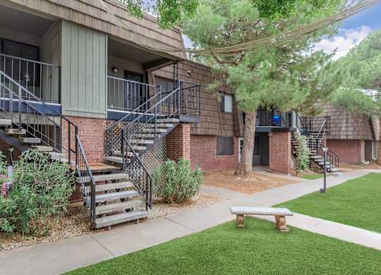 A small building with a balcony and stairs leading to the second floor.
