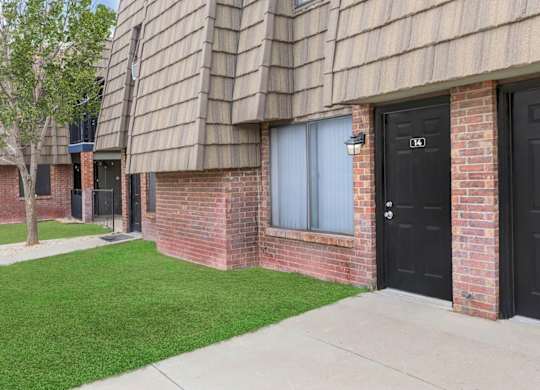 A building with black doors and windows numbered 104 and 105.