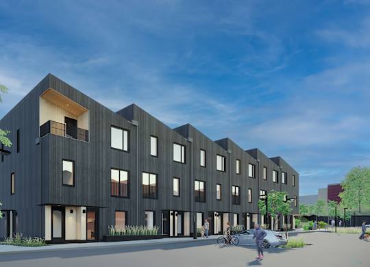 A modern building with a black facade and large windows at The Grove Apartments, Orillia