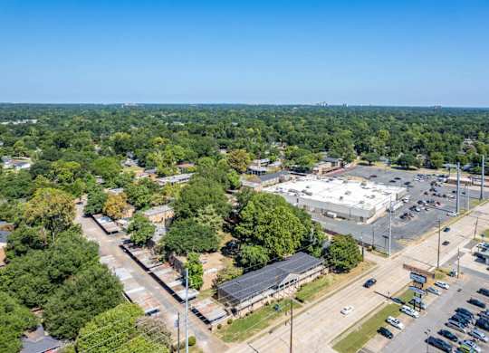 A parking lot is seen in the foreground of a sunny day.