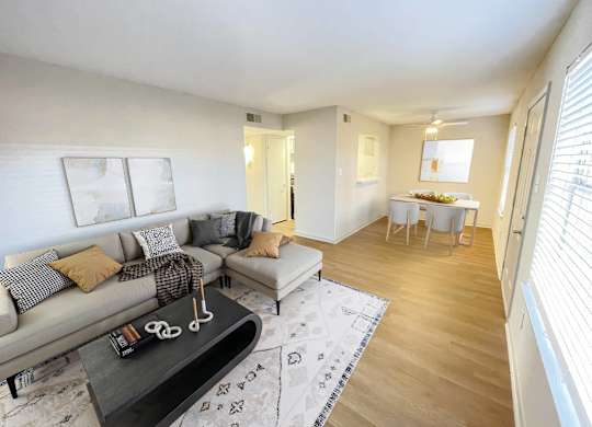 A living room with a grey couch and a coffee table.