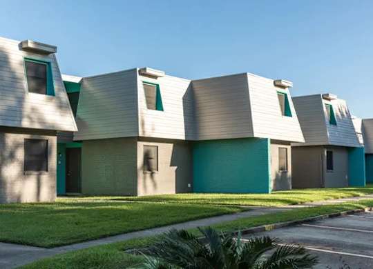 A series of houses with green doors and windows.