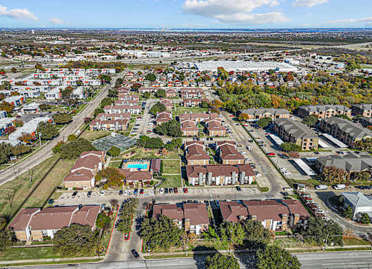 A bird's eye view of a residential area with houses and roads.