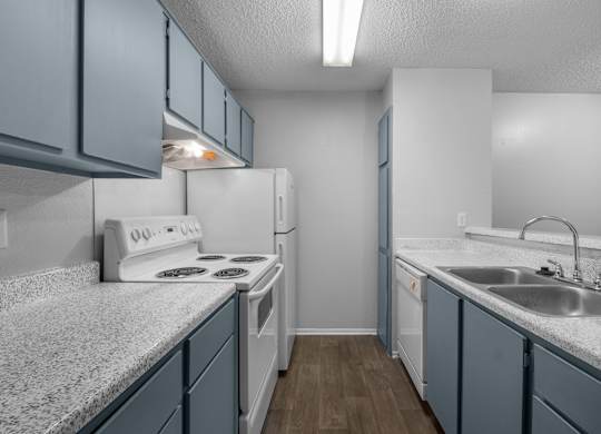 A kitchen with a white stove and blue cabinets.