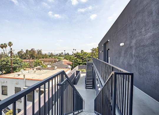 A staircase with a metal railing leads up to a building.at 5135 W Adams, Los Angeles, CA 90016