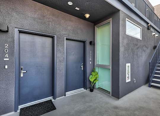 A modern house with a staircase leading to the upper floor.at 5135 W Adams, California, 90016