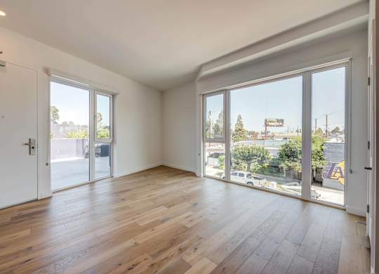 A room with wooden floors and sliding glass doors.at 5135 W Adams, California