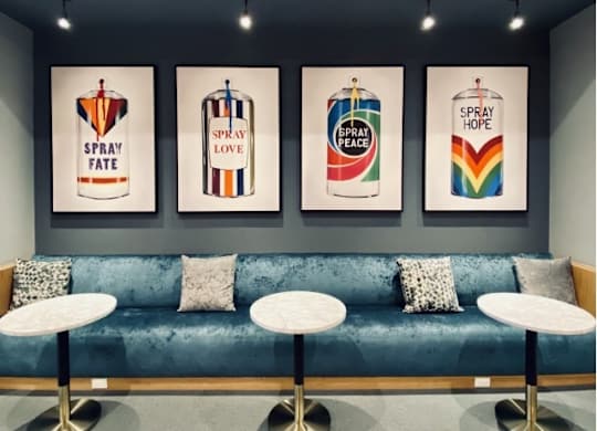 Four paintings of spray cans with different words written on them.