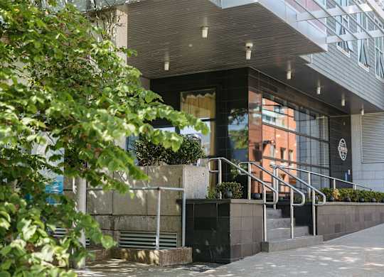 A building with a black and white logo on the wall.