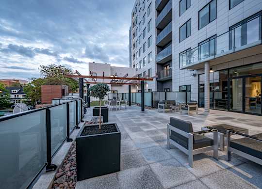 A modern patio area with benches and a table.