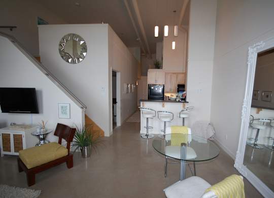 A living room with a glass table and chairs.