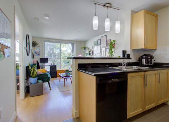 A kitchen with wooden cabinets and a black countertop.