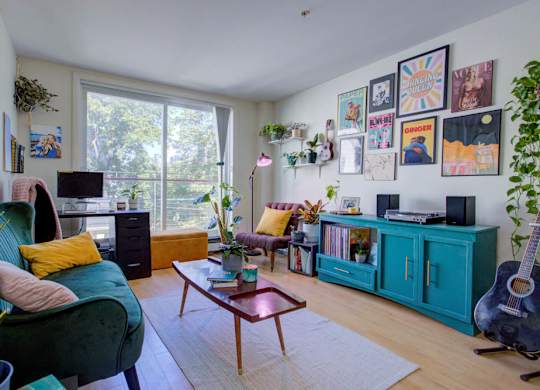 A living room with a green chair and a wooden coffee table.