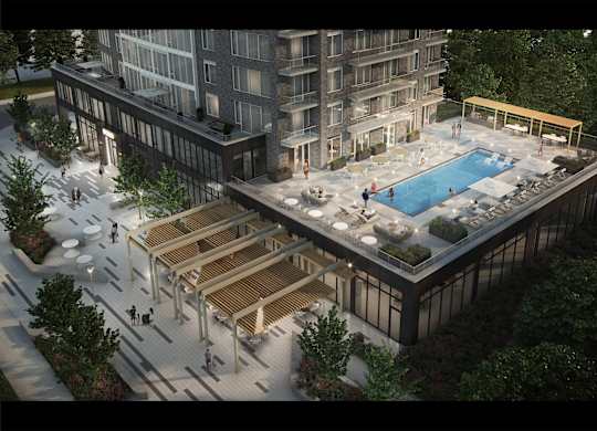 A modern building with a pool and a wooden deck.