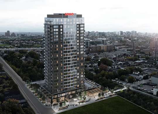 A tall building with a red sign on the top of it.
