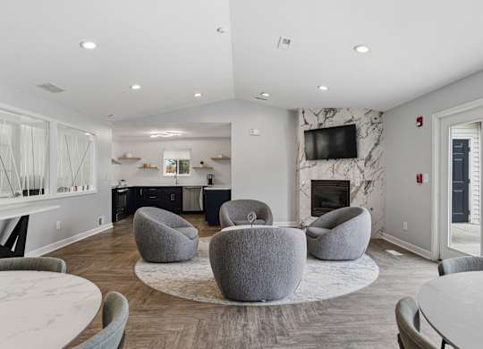 A modern living room with a fireplace and a TV mounted on the wall.