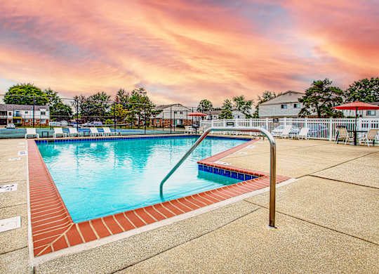 A swimming pool surrounded by a red brick border.