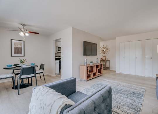 A living room with a grey couch and a wooden coffee table.