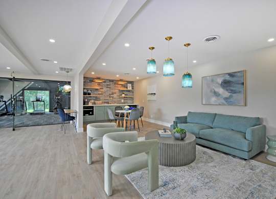 A clubhouse with a blue couch and green chairs