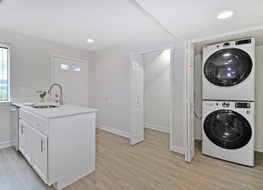 A white laundry room with a washer and dryer.