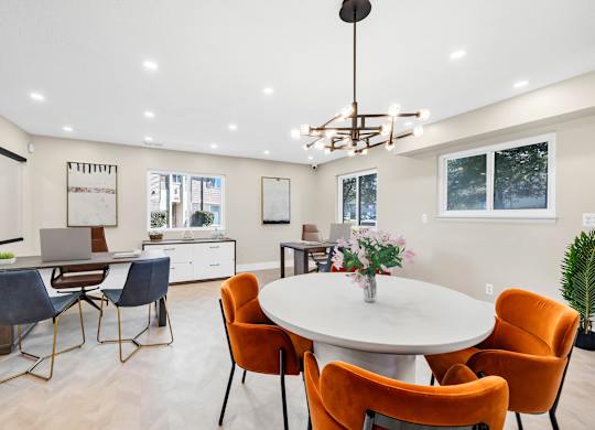 A modern clubhouse with a round table and chairs.