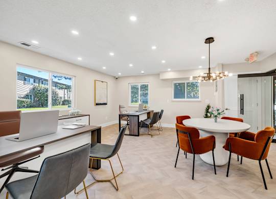 A modern clubhouse with a white table and chairs.