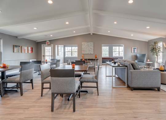 A spacious living room with a dining table and chairs.