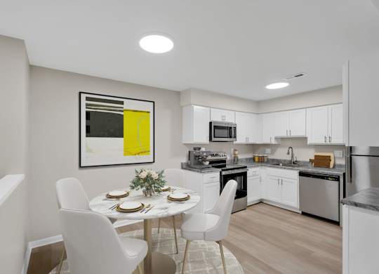 A modern kitchen with a dining table set for two.