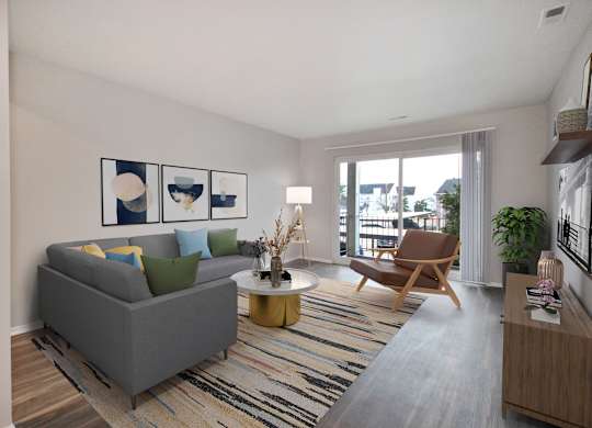 A living room with a grey couch, a wooden chair, a coffee table, and a striped rug.