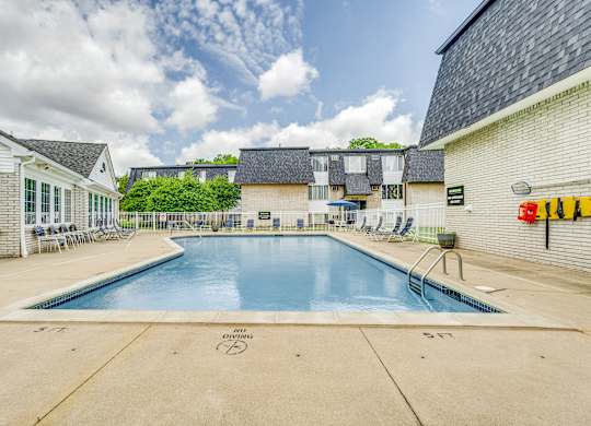 A large outdoor swimming pool with the words DIVING SHOOTING on the ground.