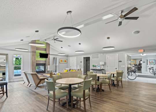 A modern dining room with a wooden floor and white walls.