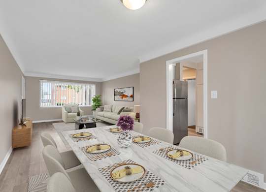 A dining room with a long table set for a meal.