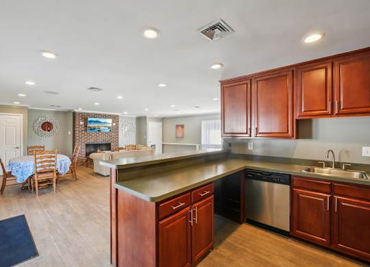 A kitchen with wooden cabinets and a stainless steel dishwasher.