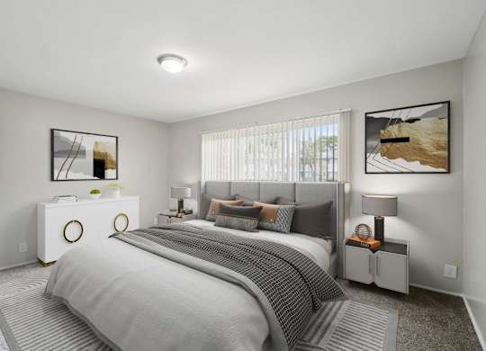 Bedroom with a large bed and two nightstands at Versailles, 25026 E Rue Versailles, Oak Park, MI 48237