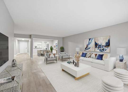 A modern living room with a white sofa and a large painting on the wall.