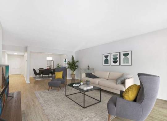 A living room with a grey armchair and a white couch.