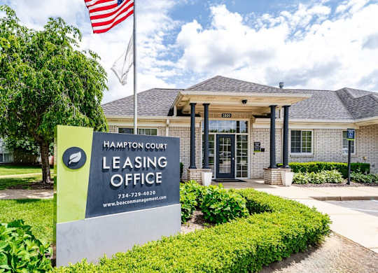 Hampton Court Leasing Office with a sign in front.