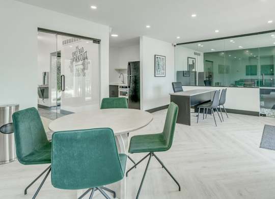 A conference room with a table and chairs.