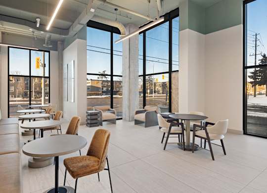 A modern dining area with a table and chairs.