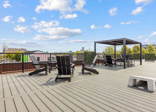 A wooden deck with chairs and a table.
